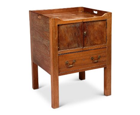 A large George III mahogany night commode
The rectangular top with pierced handles above a pair of cupboard doors and a drawe