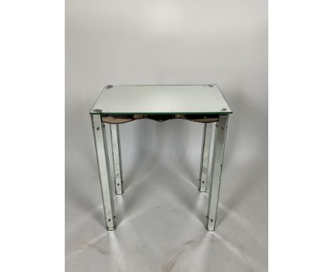 A vintage mirror glass and peach glass side table
The rectangular top above a shaped frieze on tapering mirrored legs, (leg l