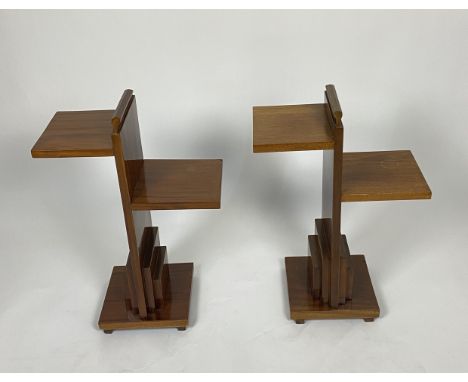 A pair of Art Deco walnut two-tiered occasional tables
Of stepped form, on plinth bases, 46cm wide, 23cm deep, 68cm high. (2)