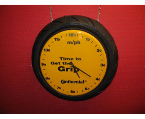 Hanging advertising battery operated electric clock for Continental Motorbike Tyres, yellow plastic face in MPH and reads Tim