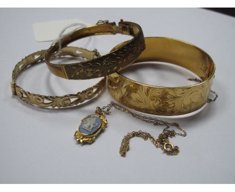 A Modern Bangle, stamped "375" (split/damages); an openwork scroll design bangle; a wide bangle stamped "9ct Gold Metal Core"