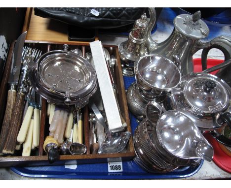 An Electroplated Three Piece Tea Service, sugar castor, coffee pot, wine coaster, loose cutlery, horn handled carving set etc