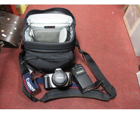 A Canon EOS 300 Camera, and a Sunpak power zoom 4000AF lens, in a canvas bag.