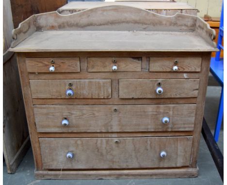 A Victorian stripped pine chest of drawers, three short drawers over two short drawers over two long, with blue and white cer