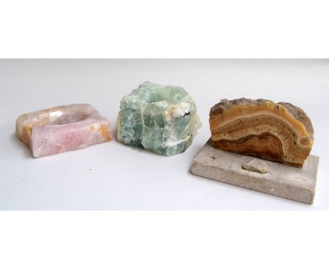 A rose quartz trinket dish, green fluorite candle holder and a polished stalactite paper-weight
