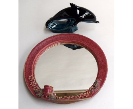 A Poole pottery dolphin and ceramic mirror with candle holder and floral decoration