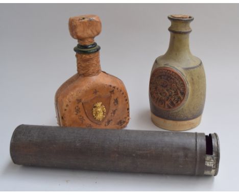 A ceramic whiskey bottle, reading '1739 Whiskey', a leather clad green glass bottle with large leather clad stopper, and a cy