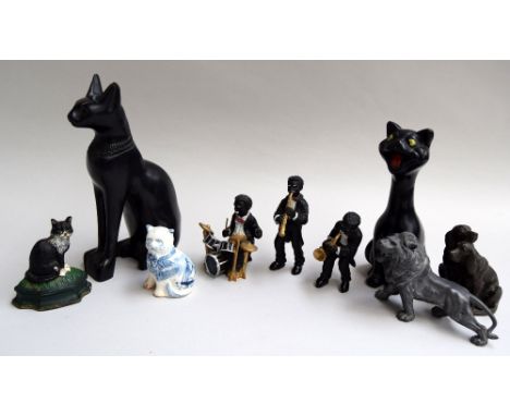 A selection of figurines, including a black Egyptian cat, a black ceramic cat, a small blue and white Staffordshire cat, thre