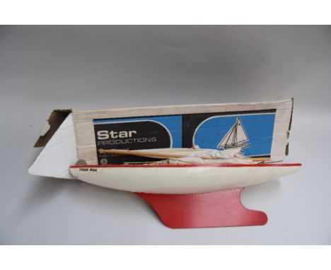 A vintage red scale model "Star" Sailing Yacht with masts, rigging and sails made by Star Productions Birkenhead, approx 55cm