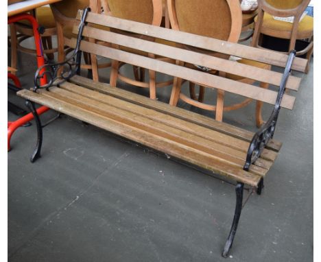 A slatted garden bench with cast iron supports, 122cmL