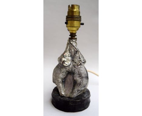 A white metal table lamp in the shape of three elephants with entwined trunks, 21.5cmH