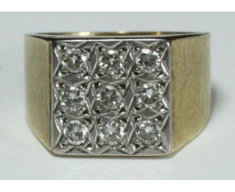 An yellow metal (tests as 18 carat gold) square-topped signet style ring set with nine round brilliant-cut diamonds.  The dia