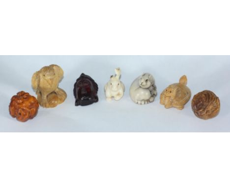 Four Japanese carved boxwood netsuke comprising turtle with dragon head, bird of prey, ball of rats, ball of dragons together