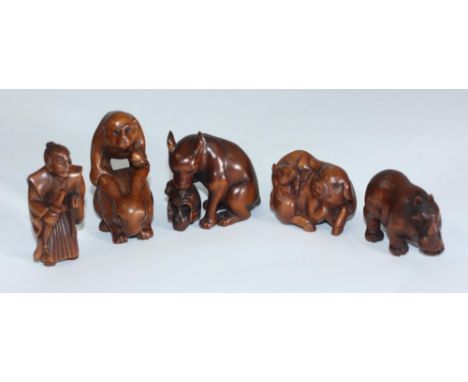 Five Japanese carved boxwood netsuke, comprising pig &amp; rat, rhino, Samurai, monkey &amp; rabbit, wolf and skull (5) 