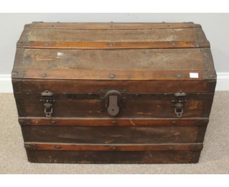 A wooden and canvas dome top trunk, with metal strap-work and locks, 77cm wide 