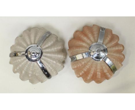 A pair of frosted glass light fittings with metal mounts and hanging chains 