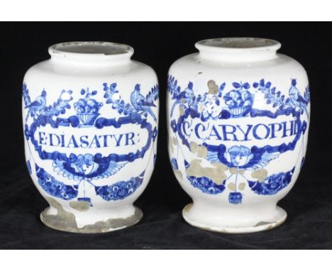 A pair of late 17th / early 18th century English delftware wet drug jars of ovoid form with flared rim and spreading foot (so