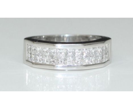 An 18 carat white gold angled wide band ring set with two rows of princess-cut diamonds.  The diamonds I colour, VS clarity, 