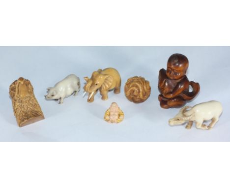Four Japanese carved boxwood netsuke comprising boy &amp; fish, elephant, eagle head and ball of snakes, together with a pott