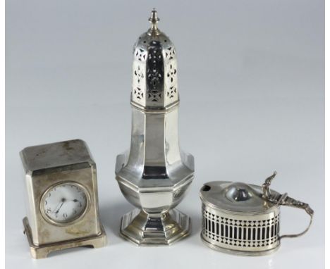 A silver sugar caster of baluster form, Birmingham, 1911, a silver mustard pot with cover and blue glass liner and a small si