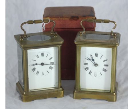 A brass carriage clock with original red leather-covered velvet-lined carry case with original key and removable panel, toget