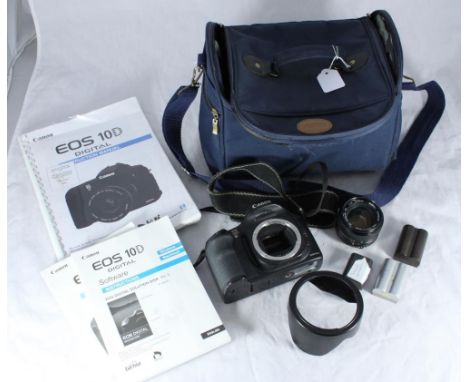 A Canon EOS 10D digital camera with instruction manuals, together with a Minolta 50mm lens and assorted battery packs etc. in