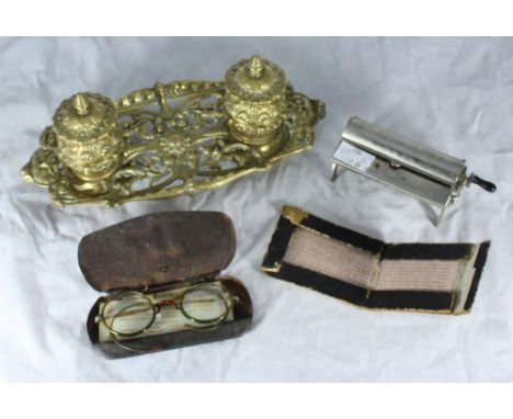A brass inkwell, tobacco rolling machine with instructions and a pair of spectacles in original case etc. 