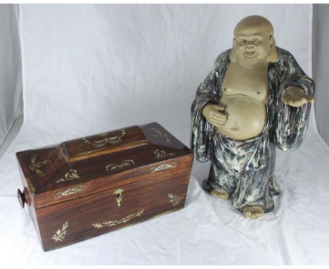 A ceramic figure of a Buddha in brown and cream robes with hand outstretched, approx. 39cm high, together with a rosewood and