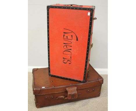 A brown leather travelling trunk, with studded top, brass lock, canvas lining and wooden bars to base, 91cm long, together wi