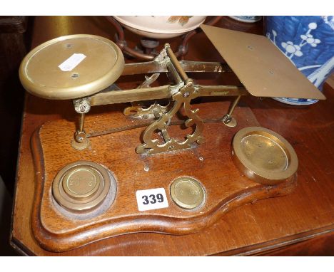 Antique brass letter scales on wooden base with brass weights