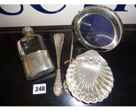 Hallmarked silver flask, silver shell shaped dish, silver photo frame and silver handled shoe horn and button hook