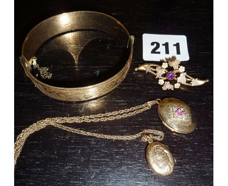Two 9ct gold lockets, one with a ruby, a 9ct gold brooch inset with a ruby, and a 9ct rolled gold bangle (gold items approx 1
