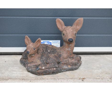 A vintage garden ornament in the form of a deer and fawn. 