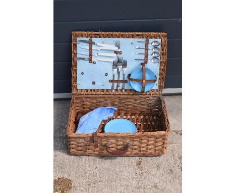 A vintage mid to late 20th century picnic set in a wicker travelling case (part set). 