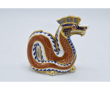 Royal Crown Derby paperweight in the form of a Dragon. 11cm tall. Boxed. First quality with gold stopper. In good condition w