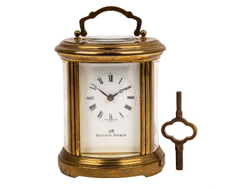   REISEUHR-MATTHEW NORMAN  Schweiz, Mitte 20.Jh., Messinggehäuse mit Klapphenkel, Handaufzug, Schlüssel anbei, H. ca. 12 cm. 