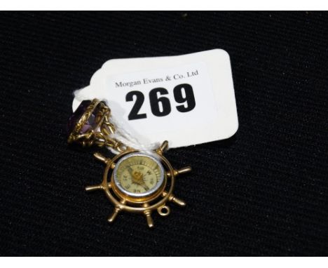     An Amethyst Seal Fob, Together With A Ships Wheel Compass Gold Fob              