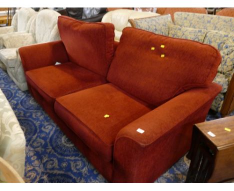 Red upholstered two seater sofa bed