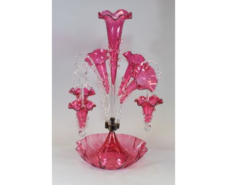 A VICTORIAN CRANBERRY GLASS FANCY EPERGNE having six alternating branches, 56cms highPlease note the epergne may be later tha
