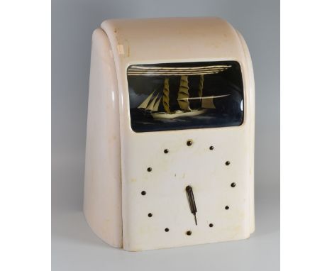 A VITASCOPE AUTOMATON CLOCK with a three masted ship at sail within a white Bakelite case (missing dial parts), 32cms high