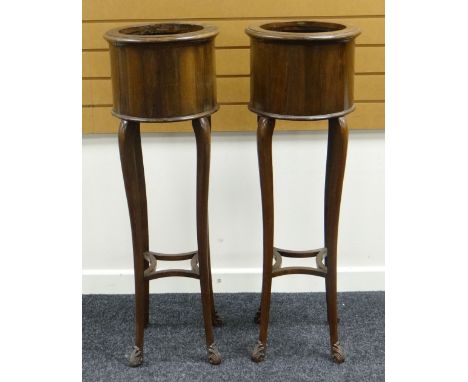 A PAIR OF JARDINIERE STANDS of cylindrical form on bow supports with lower tiers