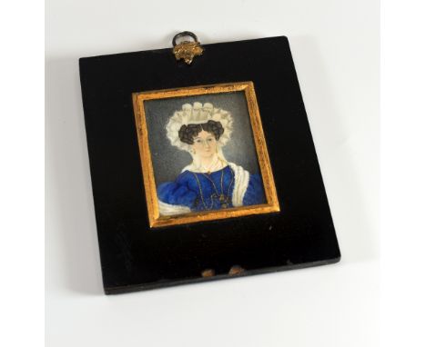 A 1787 DATED MINIATURE PORTRAIT probably on ivory and of a lady in a blue dress with jewellery and elaborate headdress, to ac