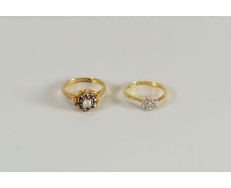 A DIAMOND FLORAL CLUSTER RING & ANOTHER