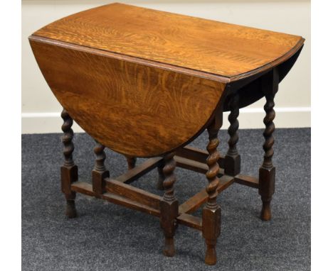 AN OAK BARLEY-TWIST GATE LEG TABLE
