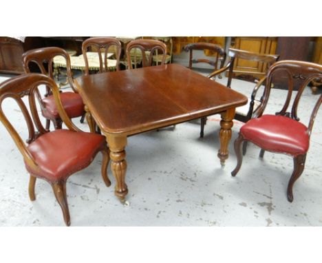 A VICTORIAN EXTENDING MAHOGANY DINING TABLE AND CHAIRS the extending table with two extra leaves on fluted shaped supports wi
