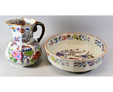 A MASONS IRONSTONE JUG & BASIN of faceted form and decorated with flowers and exotic colourful birds, the jug with serpent-fo