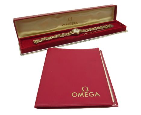 Omega, ladies 9ct gold wristwatch on integrated pierced rustic 9ct gold bracelet stamped .375, signed champagne dial with bat