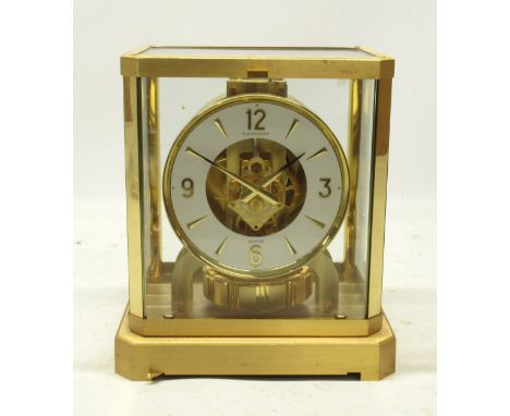 Jaeger LeCoultre Atmos gilt brass mantel timepiece, signed white enamel chapter ring set with primary Arabic and dagger indic