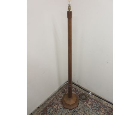 Robert Mouseman Thompson - an oak standard lamp, adzed octagonal tapering column on stepped base, carved with signature mouse