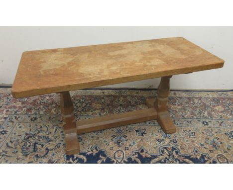 Robert Mouseman Thompson of Kilburn - an oak coffee table, adzed rectangular top, on octagonal baluster end supports with flo